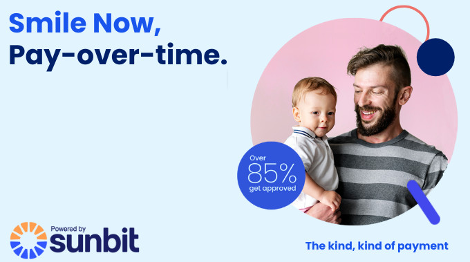 Sunbit banner - smiling father holding a baby